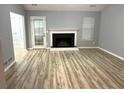 Spacious living room with fireplace, wood floors, gray walls, and natural light at 1255 Summit Point Ln, Snellville, GA 30078