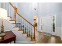 Welcoming entryway with hardwood floors, staircase, and natural light at 2759 Beddington Way, Suwanee, GA 30024