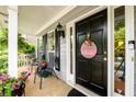 Inviting covered front porch with seating area, perfect for enjoying a quiet moment at 2759 Beddington Way, Suwanee, GA 30024