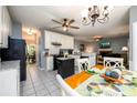 Open kitchen and living area with granite countertops, white cabinets, and stainless steel appliances at 2759 Beddington Way, Suwanee, GA 30024