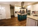 Bright kitchen featuring stainless steel appliances, gas cooktop on island, granite countertops, and gorgeous wood floors at 308 Forkwood Trl, Woodstock, GA 30189