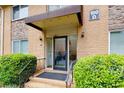 Apartment building entrance showing a brick facade, stone accents, a covered doorway, and manicured landscaping at 100 Biscayne Nw Dr # D7, Atlanta, GA 30309