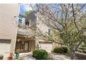 Inviting townhome featuring an attached garage and flowering tree at 1127 Riverbend Club Se Dr, Atlanta, GA 30339