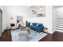 Comfortable living room with hardwood floors, modern furniture, and staircase to second floor at 1127 Riverbend Club Se Dr, Atlanta, GA 30339