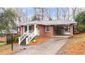 Attractive brick home featuring a covered carport and a welcoming front porch at 2044 Wilandrew Dr, Decatur, GA 30033