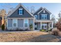 Beautiful two-story home with a covered front porch, stone accents, and well-manicured lawn at 15 Parkside Vw, Cartersville, GA 30121