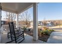 Relaxing front porch with rocking chairs and a view of the well-maintained neighborhood at 15 Parkside Vw, Cartersville, GA 30121