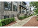 Townhouse showcases a sidewalk and landscaped bushes leading to the front door at 1598 Aldworth Se Pl, Marietta, GA 30067