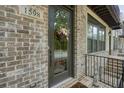 Charming front door with glass pane and wreath, set in a brick facade at 1598 Aldworth Se Pl, Marietta, GA 30067