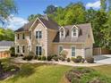 Beautiful home featuring manicured landscaping, a charming facade, and an attached garage for convenient parking at 1770 Laurel Creek Dr, Lawrenceville, GA 30043
