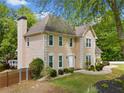 Classic two-story home boasts a well-maintained lawn and a charming facade with an attached two car garage at 1770 Laurel Creek Dr, Lawrenceville, GA 30043