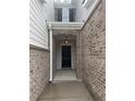 Front door entrance with hanging light fixture in brick and grey siding entryway at 1155 Park Center Cir, Austell, GA 30168