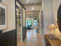 Bright hallway with hardwood floors leads to an open-concept living area, with light wood and recessed lighting at 210 Mooney Rd, Woodstock, GA 30188
