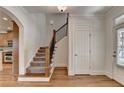 Hallway featuring hardwood floors, stairs, and a view into the kitchen at 375 Causeway Ct, Suwanee, GA 30024