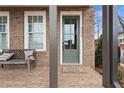 Inviting brick front porch with a bench and an green front door, enhancing curb appeal at 4200 Legacy Ln # 22, Acworth, GA 30101
