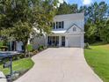 Lovely two-story home with lush landscaping, a well-maintained lawn, and an inviting driveway at 11255 Wittenridge Dr, Alpharetta, GA 30022