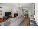 Cozy living room with a fireplace, hardwood floors, and lots of natural light at 11255 Wittenridge Dr, Alpharetta, GA 30022