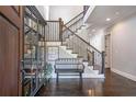 Elegant foyer with hardwood floors, staircase, and stylish bench at 2370 Bradwardine Ct, Cumming, GA 30041