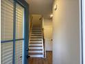 Inviting entryway featuring stairs with wooden handrail, leading to the upper level and brightened by a side window at 2409 Malster Ln, Lawrenceville, GA 30043
