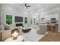 Bright and airy living room featuring a fireplace, hardwood floors, and an open floor plan at 3902 Bouldercrest Se Rd, Ellenwood, GA 30294