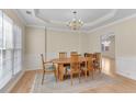 Cozy dining room with a chandelier, wainscoting and a large window at 1107 Carroll Ct, Norcross, GA 30071