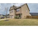 Spacious two-story home with brick accents and a two-car garage, complemented by a green lawn and young tree at 1262 Brookstone Cir, Conyers, GA 30012