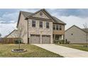 Well-maintained two-story home with brick and shingle siding, showcasing a two-car garage and landscaped front yard at 1262 Brookstone Cir, Conyers, GA 30012