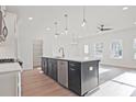 Bright, open kitchen featuring a large island, stainless steel appliances, and hardwood floors at 213 Admor Ln, Acworth, GA 30102