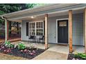 Inviting front porch with stylish seating and lush landscaping, perfect for relaxing outdoors at 2565 Bates Se St, Smyrna, GA 30080