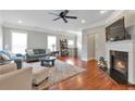 Open-concept living room with fireplace and hardwood floors at 2690 Derby Ne Walk # 53, Atlanta, GA 30319