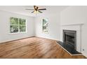Sunlit living room featuring new floors, a cozy fireplace, and large windows offering neighborhood views at 2746 Sanibel Se Ln, Smyrna, GA 30082