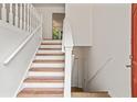 Bright staircase with white railings and wood steps, leading to the upper level of the home at 2746 Sanibel Se Ln, Smyrna, GA 30082