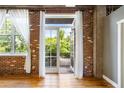 An open balcony with exposed brickwork offering a serene view of lush greenery at 3235 Roswell Ne Rd # 521, Atlanta, GA 30305