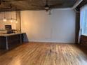 Spacious living room with hardwood floors, an open ceiling, ductwork and a kitchen area visible at 3235 Roswell Ne Rd # 521, Atlanta, GA 30305