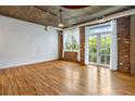 Spacious living room featuring exposed brick, hardwood floors, and abundant natural light at 3235 Roswell Ne Rd # 521, Atlanta, GA 30305