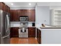 Well-equipped kitchen featuring stainless steel appliances, stylish wood cabinetry, and ample counter space at 375 Highland Ne Ave # 913, Atlanta, GA 30312