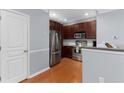 Cozy kitchen showcasing stainless steel appliances, dark wood cabinets, and hardwood flooring at 375 Highland Ne Ave # 913, Atlanta, GA 30312
