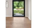 Entryway with hardwood floors looking through a glass front door to a lawn at 4091 Oak Forest Ne Dr, Brookhaven, GA 30319