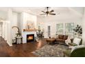 Inviting living room featuring a cozy fireplace, hardwood floors, and ample natural light at 110 Peach Pointe Dr, Mcdonough, GA 30253