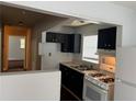 Compact kitchen featuring black cabinetry, white appliances, and a functional layout. Easy to prepare delicious meals at 226 Walnut Nw St, Atlanta, GA 30314