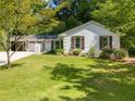 Delightful single-story home with white brick, complemented by dark shutters and a lush green lawn at 3176 Gablewood Ct, Decatur, GA 30033