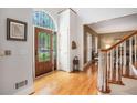 Elegant foyer featuring hardwood floors, decorative door with glass and wrought iron, and staircase at 3845 Winters Hill Dr, Atlanta, GA 30360