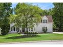 Stately home with lush lawn and mature tree providing ample shade on a sunny day at 3845 Winters Hill Dr, Atlanta, GA 30360