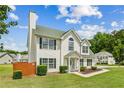 Classic two-story home featuring vinyl siding, a chimney, and a well-maintained lawn at 5273 High Tide Ct, Atlanta, GA 30349