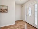 Inviting foyer with beautiful hardwood floors, a decorative front door, and neutral wall paint at 5273 High Tide Ct, Atlanta, GA 30349