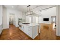 Spacious kitchen with island opens to living room in an open-concept design; great for entertaining at 9179 Selborne Ln, Chattahoochee Hills, GA 30268