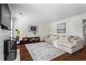 Spacious living room features stylish decor, a comfortable sectional, and ample natural light at 1028 Riverbend Club Se Dr, Atlanta, GA 30339