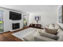 Inviting living area boasts a fireplace, large TV, and a comfortable sectional sofa at 1028 Riverbend Club Se Dr, Atlanta, GA 30339