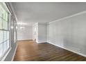 Open-concept living space with hardwood floors, connecting seamlessly to the dining area at 1819 King Alfred Sw Dr, Atlanta, GA 30331
