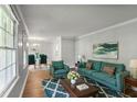 Bright living room with hardwood floors and modern decor, complemented by large windows at 1819 King Alfred Sw Dr, Atlanta, GA 30331